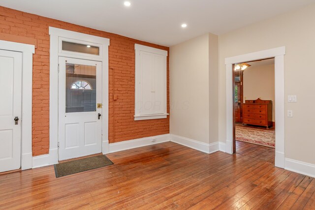 1366 S 4th St, Columbus, OH 43207 - foyer entrance featuring hardwood / wood-style flooring, brick wall, plenty of natural light, and recessed lighting