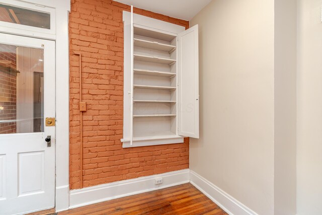 1366 S 4th St, Columbus, OH 43207 - detailed view of wood finished floors and brick wall