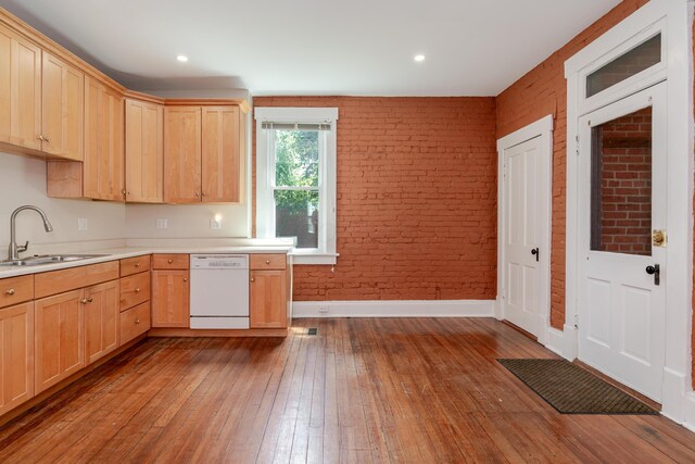 1366 S 4th St, Columbus, OH 43207 - kitchen with dishwasher, light brown cabinets, brick wall, wood-type flooring, and light countertops