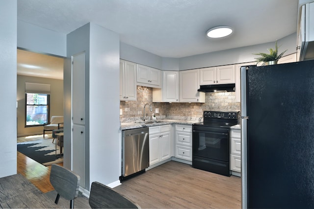 1820 Willoway Cir S, Columbus, OH 43220 - kitchen with appliances with stainless steel finishes, light wood finished floors, under cabinet range hood, decorative backsplash, and white cabinets
