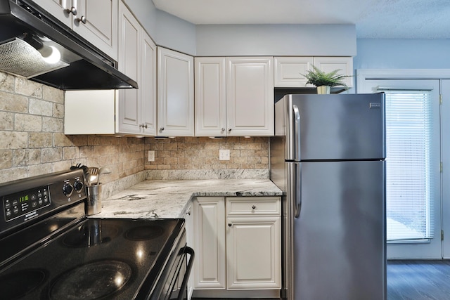 1820 Willoway Cir S, Columbus, OH 43220 - kitchen featuring freestanding refrigerator, electric range oven, under cabinet range hood, white cabinetry, and tasteful backsplash