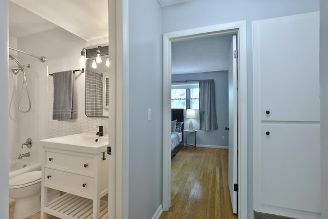 1820 Willoway Cir S, Columbus, OH 43220 - ensuite bathroom featuring vanity, tasteful backsplash,  shower combination, and wood finished floors