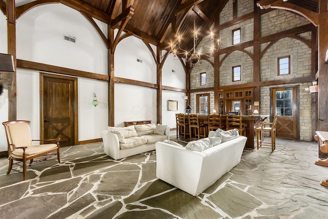 6065 Craughwell Ln, Dublin, OH 43017 - living room featuring high vaulted ceiling, stone flooring, a chandelier, and a wooden ceiling with exposed beams