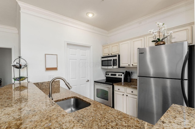 6065 Craughwell Ln, Dublin, OH 43017 - kitchen featuring appliances with stainless steel finishes, crown molding, light stone counters, and cream cabinets