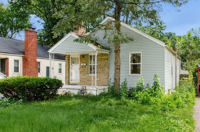 178 S Weyant Ave, Columbus, OH 43213 - view of front of home with a porch, a chimney, and a front lawn