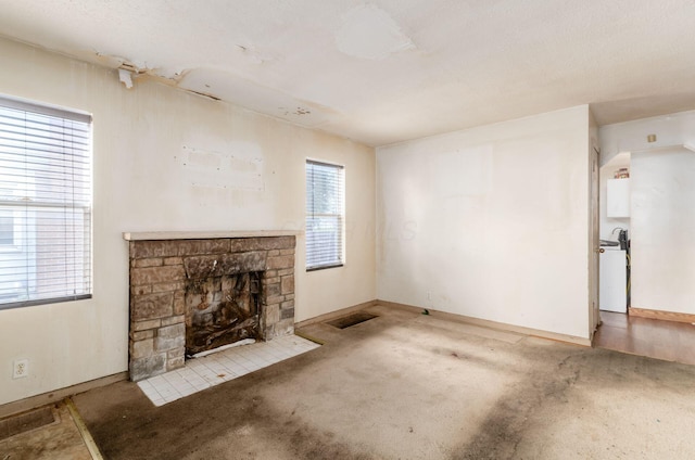 178 S Weyant Ave, Columbus, OH 43213 - unfurnished living room with a stone fireplace and carpet flooring