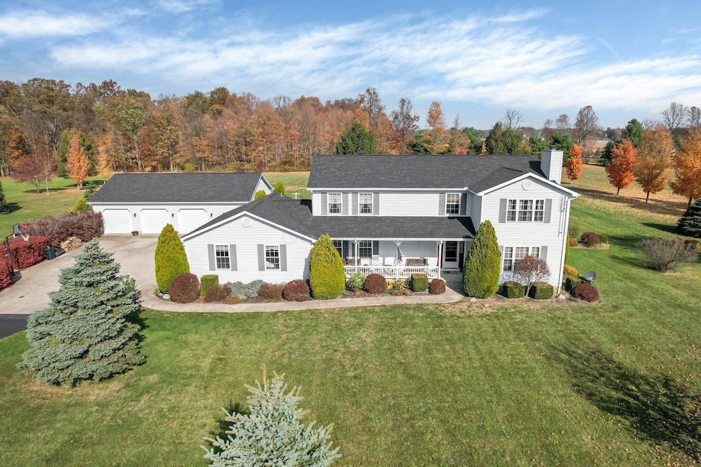 3081 Township Rd Unit 223, Marengo, OH 43334 - traditional home with covered porch, a chimney, a garage, a front yard, and concrete driveway