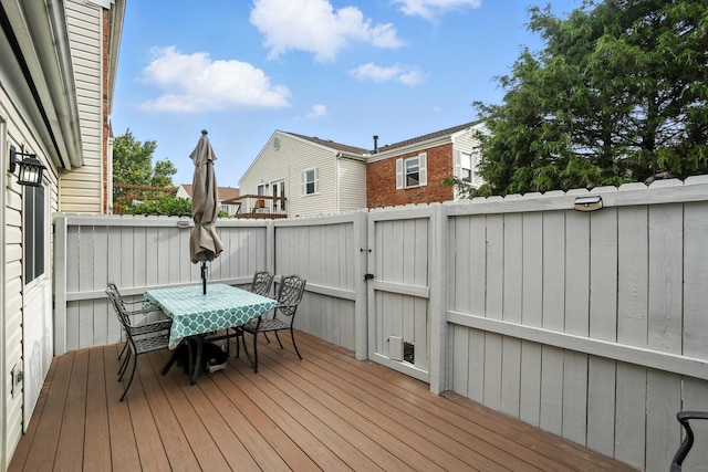 3063 Jersey Dr Unit 67, Columbus, OH 43204 - wooden deck with outdoor dining space and a gate