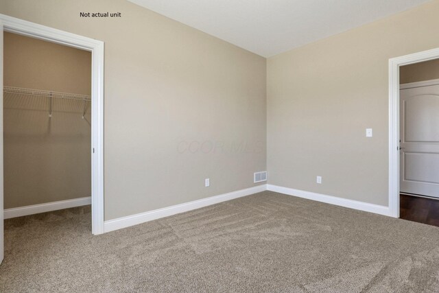 7641 Clifton Loop, Pickerington, OH 43147 - unfurnished bedroom featuring carpet and a walk in closet