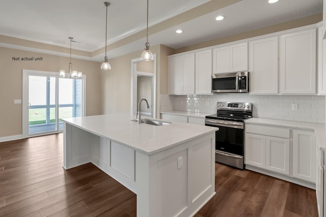 7641 Clifton Loop, Pickerington, OH 43147 - kitchen with appliances with stainless steel finishes, backsplash, dark wood-style floors, a kitchen island with sink, and recessed lighting