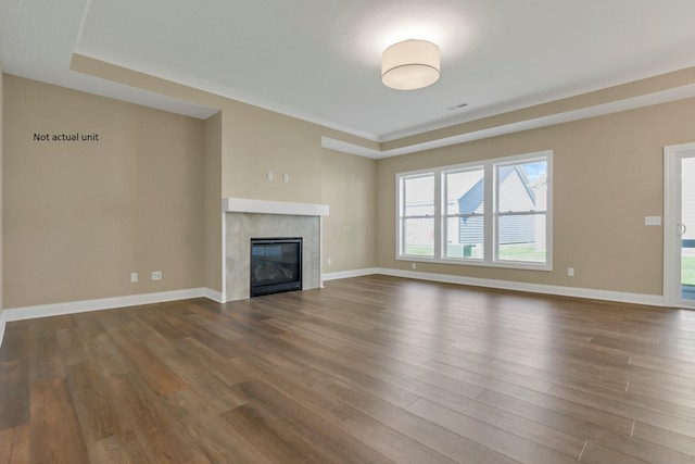 7641 Clifton Loop, Pickerington, OH 43147 - unfurnished living room with dark wood-style flooring, a tiled fireplace, and ornamental molding