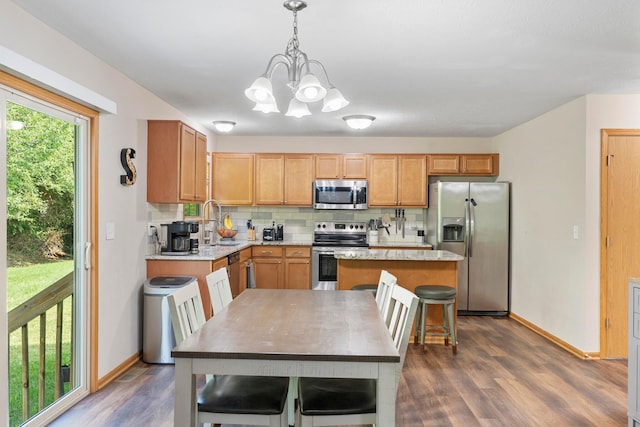 3615 Motts Place Ct, Canal Winchester, OH 43110 - kitchen featuring appliances with stainless steel finishes, dark wood finished floors, backsplash, a chandelier, and a center island
