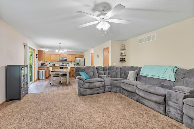 3615 Motts Place Ct, Canal Winchester, OH 43110 - living area featuring light colored carpet, a chandelier, and ceiling fan