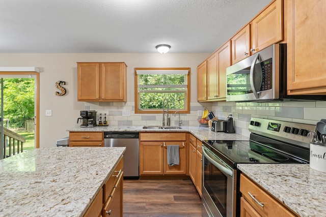 3615 Motts Place Ct, Canal Winchester, OH 43110 - kitchen featuring appliances with stainless steel finishes, healthy amount of natural light, dark wood-style floors, decorative backsplash, and a textured ceiling