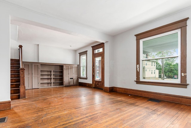 356 E 20th Ave, Columbus, OH 43201 - unfurnished living room featuring wood-type flooring, plenty of natural light, and stairway