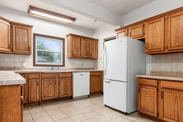 356 E 20th Ave, Columbus, OH 43201 - kitchen featuring white appliances, tasteful backsplash, brown cabinets, and light tile patterned floors