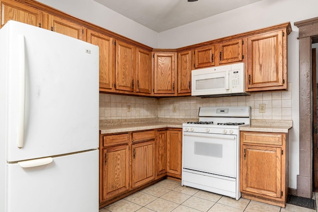 356 E 20th Ave, Columbus, OH 43201 - kitchen featuring white appliances, light countertops, brown cabinets, and tasteful backsplash