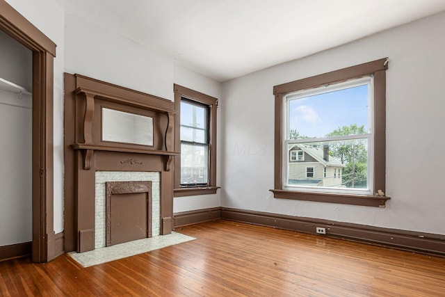 356 E 20th Ave, Columbus, OH 43201 - unfurnished living room with a fireplace with flush hearth and hardwood / wood-style flooring