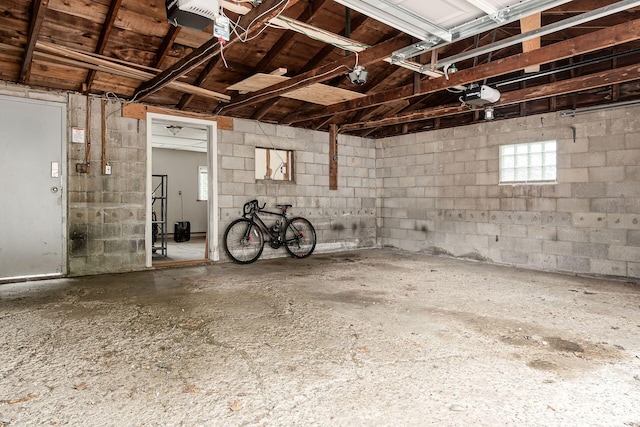 356 E 20th Ave, Columbus, OH 43201 - garage with a garage door opener and concrete block wall