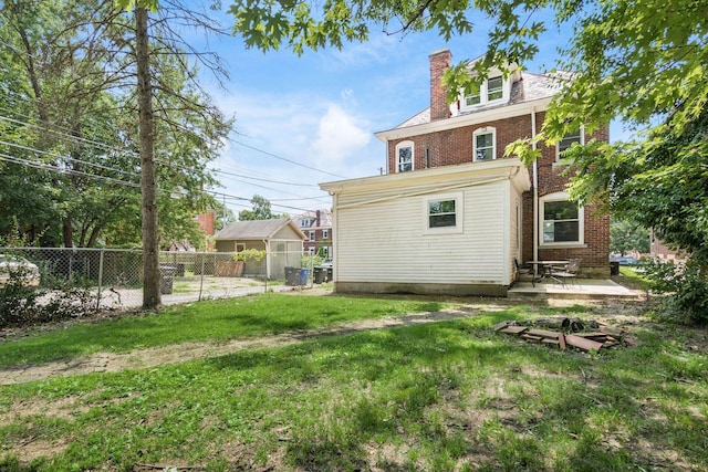 356 E 20th Ave, Columbus, OH 43201 - rear view of property featuring brick siding, a chimney, and a patio area