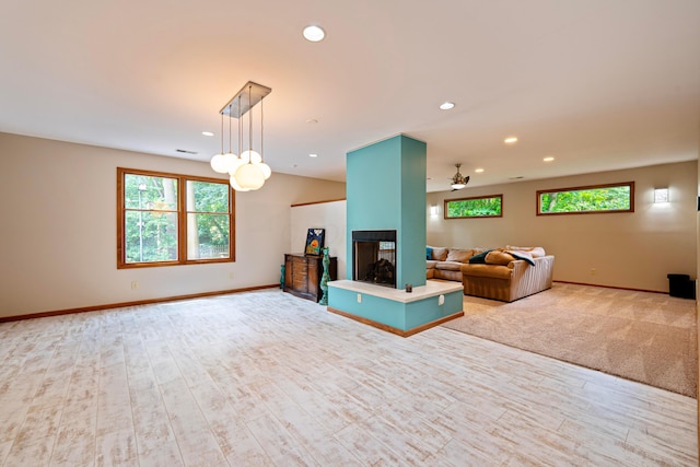 175 Academy Woods Dr, Columbus, OH 43230 - living room featuring healthy amount of natural light, recessed lighting, wood finished floors, and a multi sided fireplace