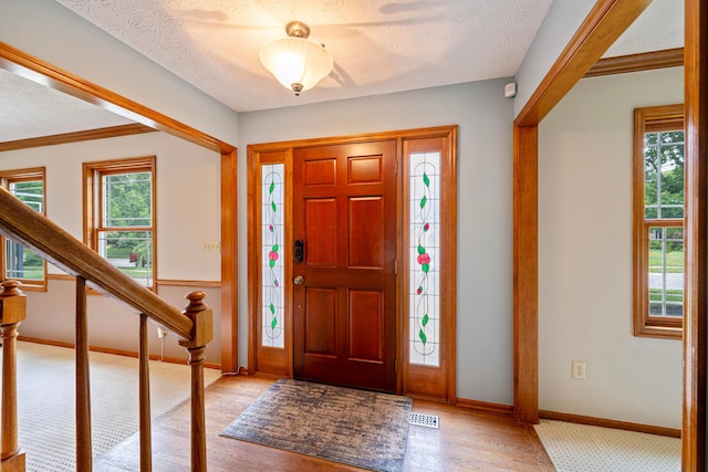 175 Academy Woods Dr, Columbus, OH 43230 - entryway with plenty of natural light, light wood-style flooring, a textured ceiling, and stairs