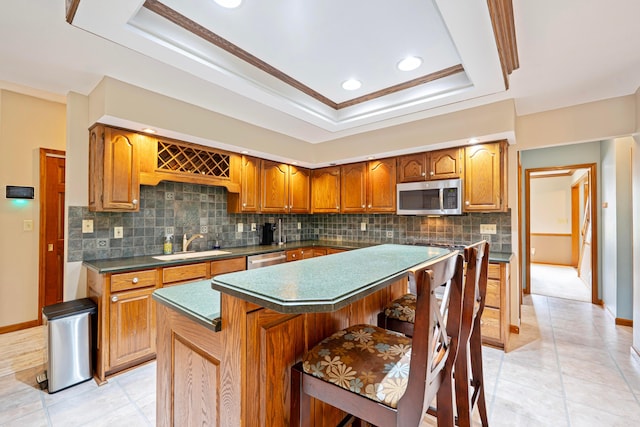 175 Academy Woods Dr, Columbus, OH 43230 - kitchen with stainless steel appliances, decorative backsplash, dark countertops, a tray ceiling, and crown molding