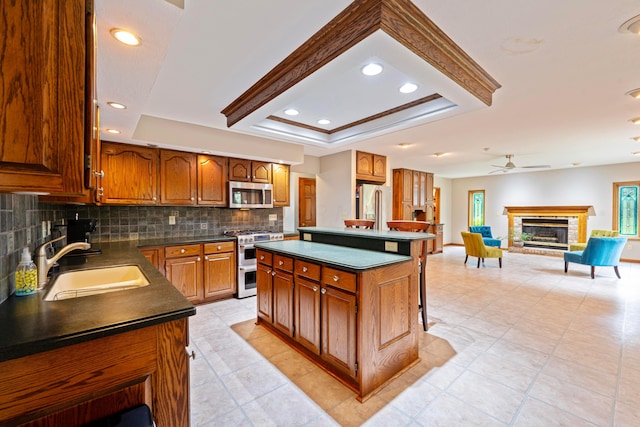 175 Academy Woods Dr, Columbus, OH 43230 - kitchen featuring appliances with stainless steel finishes, dark countertops, a raised ceiling, backsplash, and recessed lighting