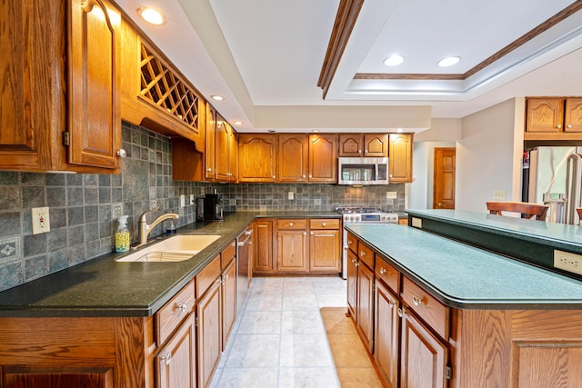 175 Academy Woods Dr, Columbus, OH 43230 - kitchen with stainless steel appliances, a tray ceiling, dark countertops, decorative backsplash, and brown cabinetry