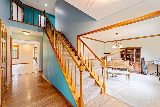 175 Academy Woods Dr, Columbus, OH 43230 - stairway featuring wood finished floors and a chandelier