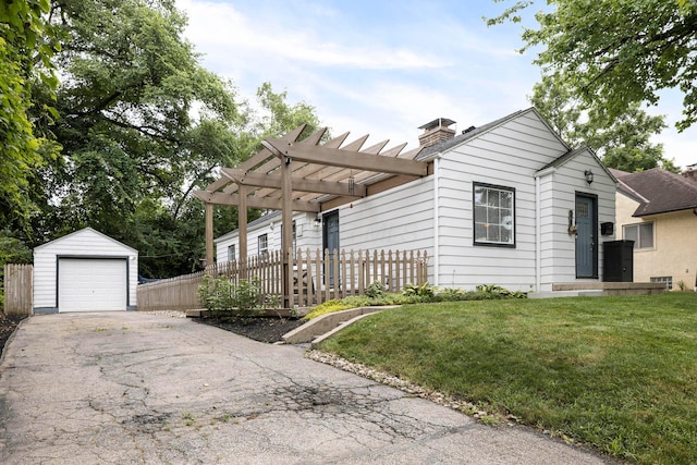 528 S James Rd, Columbus, OH 43213 - view of front of house with an outdoor structure, a chimney, a pergola, and asphalt driveway