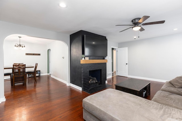 528 S James Rd, Columbus, OH 43213 - living area featuring arched walkways, ceiling fan, a chandelier, a brick fireplace, and recessed lighting