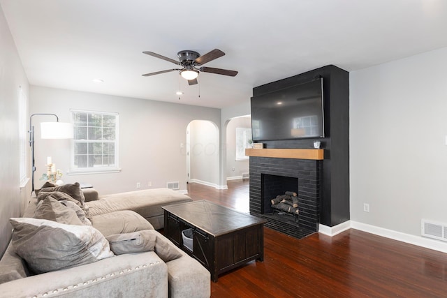 528 S James Rd, Columbus, OH 43213 - living area with arched walkways, dark wood-style flooring, a ceiling fan, a brick fireplace, and recessed lighting