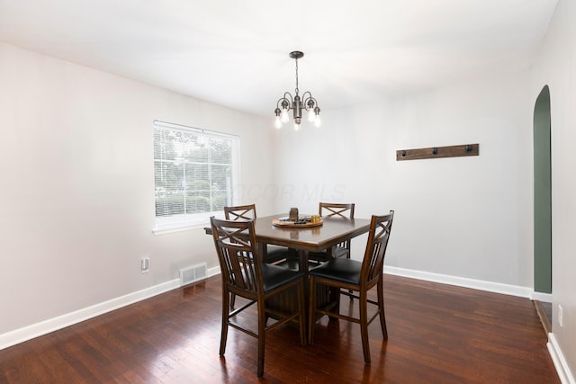 528 S James Rd, Columbus, OH 43213 - dining space with arched walkways, dark wood-style floors, and a chandelier