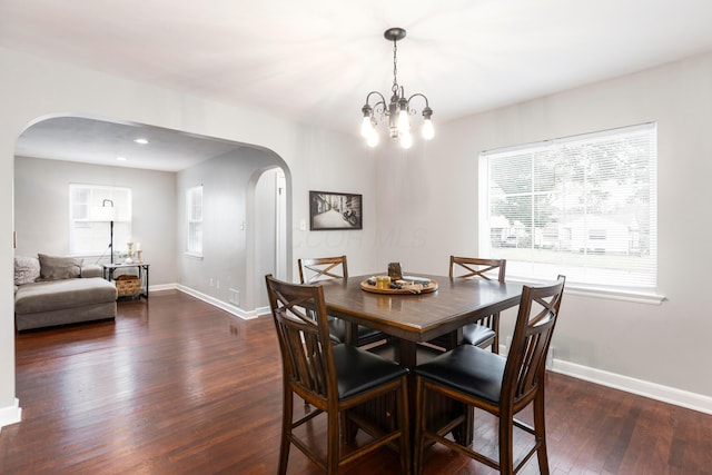 528 S James Rd, Columbus, OH 43213 - dining area featuring arched walkways, dark wood-style flooring, and a chandelier