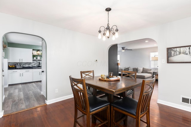 528 S James Rd, Columbus, OH 43213 - dining area featuring arched walkways, a ceiling fan, dark wood-style floors, a chandelier, and recessed lighting