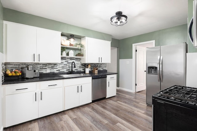 528 S James Rd, Columbus, OH 43213 - kitchen with stainless steel appliances, dark countertops, open shelves, and tasteful backsplash