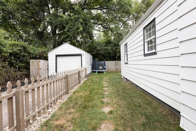 528 S James Rd, Columbus, OH 43213 - view of yard with a trampoline, an outbuilding, and a garage