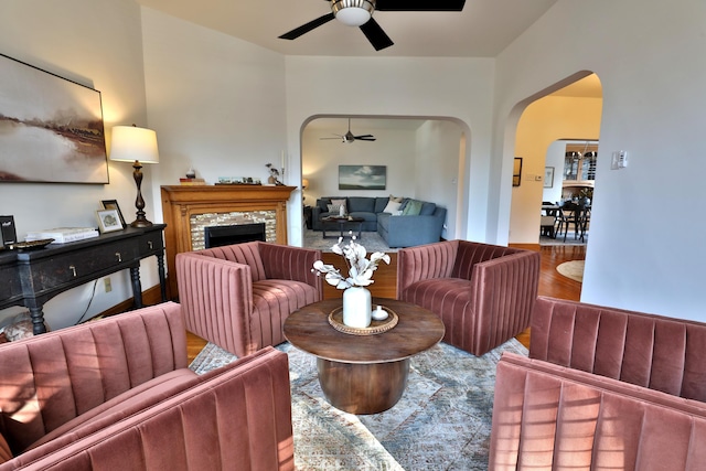 398 W 5th Ave, Columbus, OH 43201 - living area with a ceiling fan, arched walkways, wood finished floors, and a fireplace
