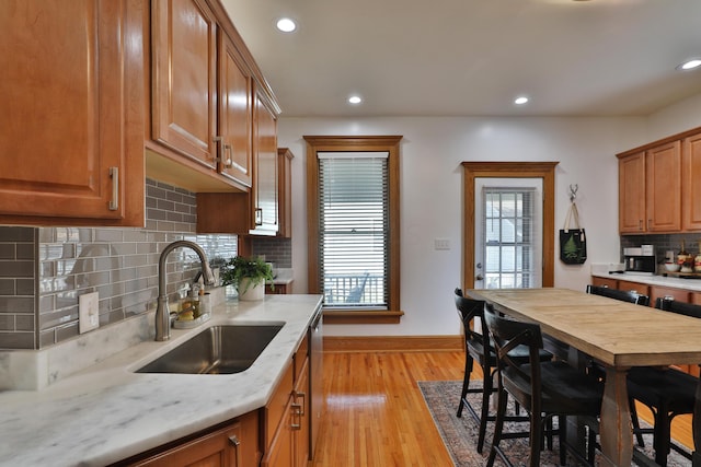 398 W 5th Ave, Columbus, OH 43201 - kitchen featuring decorative backsplash, brown cabinets, recessed lighting, light wood-style floors, and dishwasher
