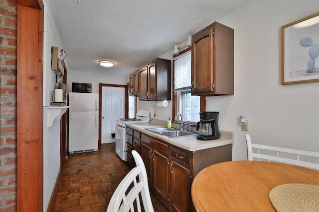 398 W 5th Ave, Columbus, OH 43201 - kitchen featuring white appliances, light countertops, and dark brown cabinets