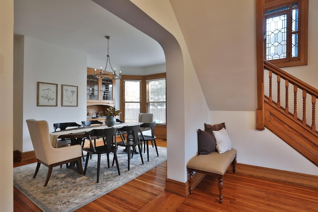 398 W 5th Ave, Columbus, OH 43201 - dining room featuring wood finished floors, healthy amount of natural light, a chandelier, and arched walkways