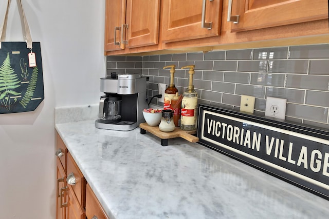 398 W 5th Ave, Columbus, OH 43201 - kitchen with brown cabinetry, backsplash, and light stone countertops