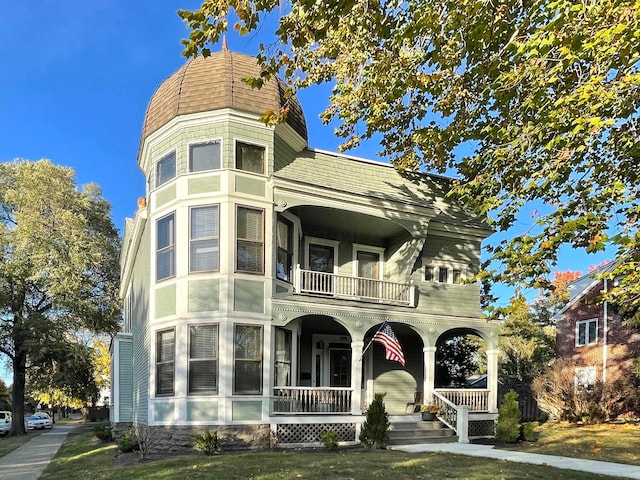 398 W 5th Ave, Columbus, OH 43201 - view of front facade with a balcony, a porch, and a front yard