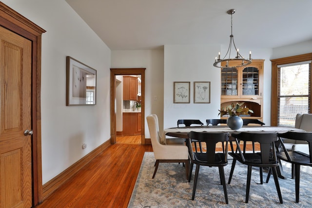 398 W 5th Ave, Columbus, OH 43201 - dining area featuring wood finished floors and a chandelier