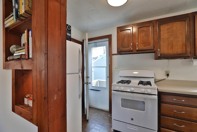 398 W 5th Ave, Columbus, OH 43201 - kitchen featuring white appliances, light countertops, and brown cabinets
