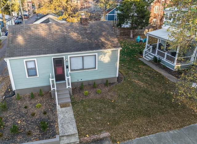 398 W 5th Ave, Columbus, OH 43201 - view of front of house with a shingled roof and a chimney