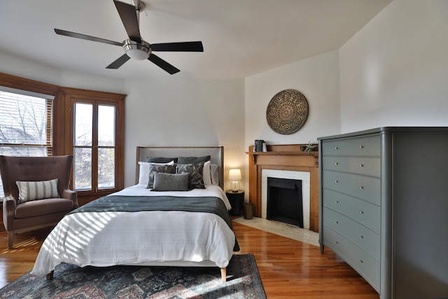 398 W 5th Ave, Columbus, OH 43201 - bedroom featuring wood finished floors, ceiling fan, and a fireplace