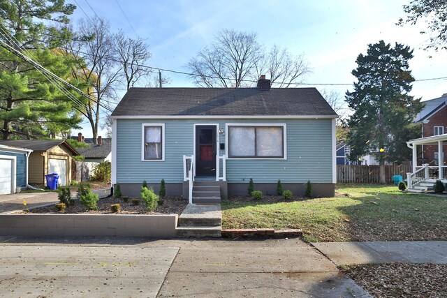 398 W 5th Ave, Columbus, OH 43201 - bungalow-style house featuring an outbuilding, a chimney, and roof with shingles