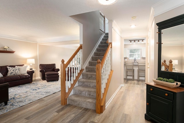 6258 Tetlin Field Dr, New Albany, OH 43054 - stairway featuring wood finished floors and crown molding
